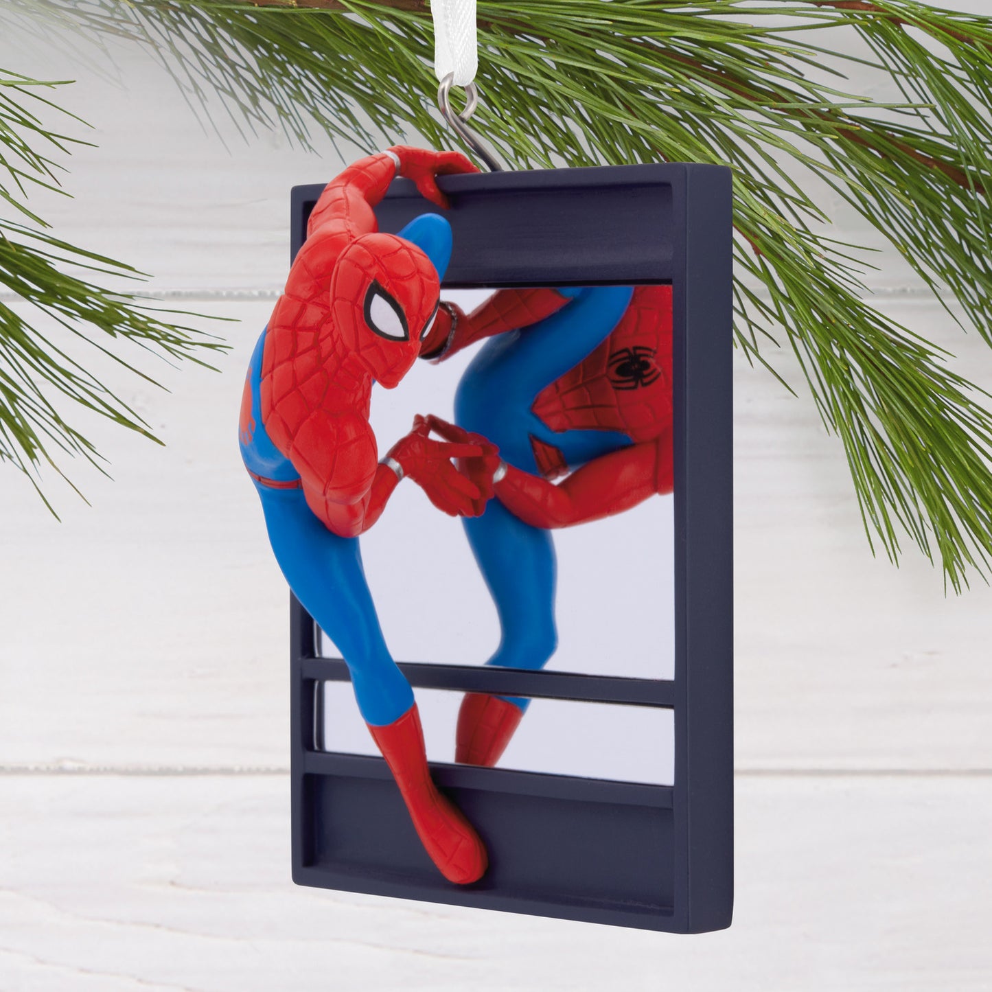 Hallmark Christmas ornament - Marvel Spider-Man on window, colourful action figure scaling a frame against a pine backdrop.
