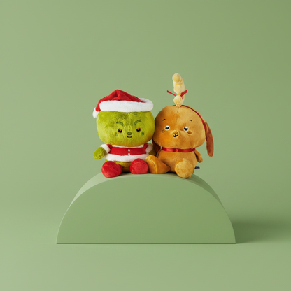 Two plush toys, one green and one brown, sitting on a green platform against a light green background.