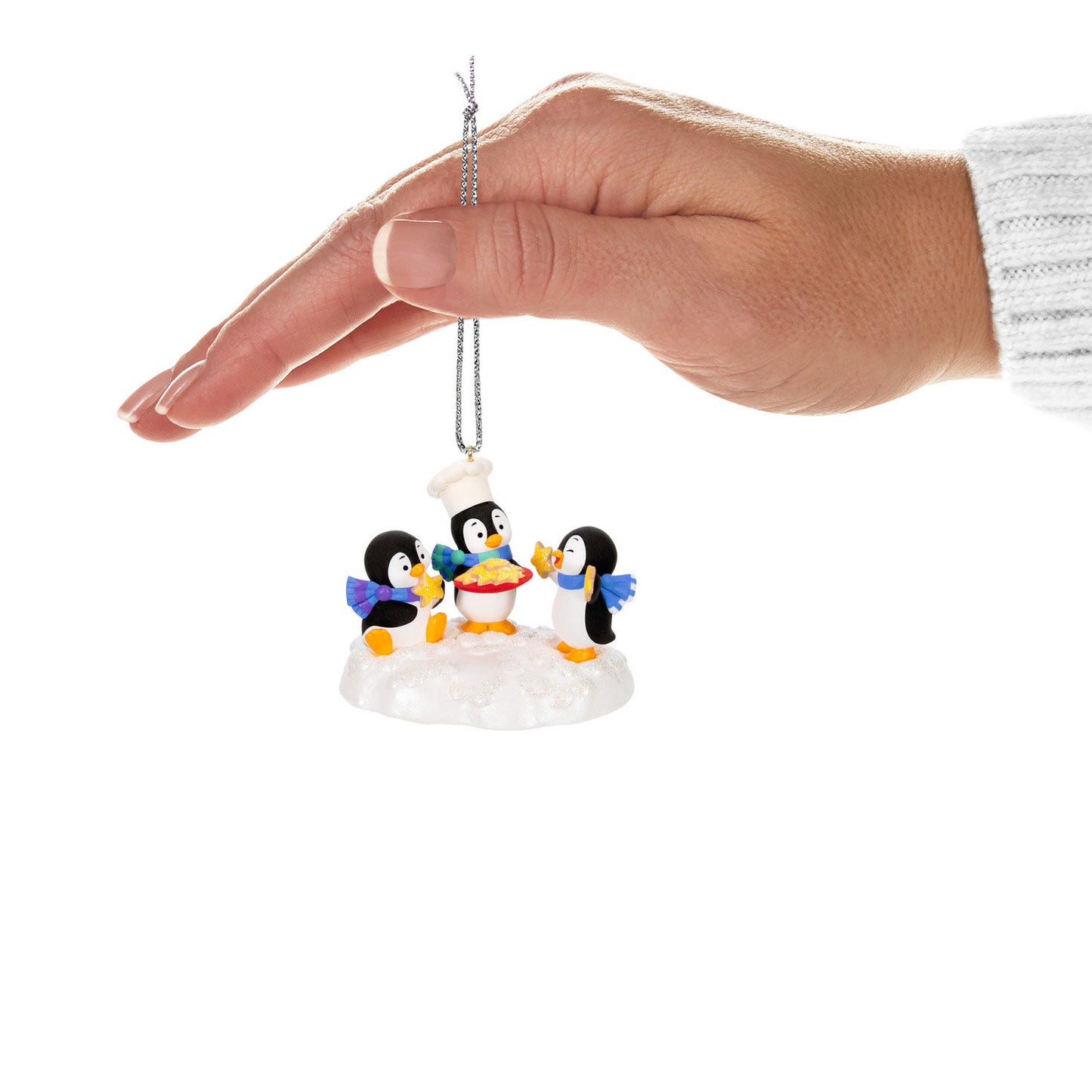 Cookie Exchange — Hallmark Keepsake Christmas Ornament, plastic, featuring playful penguins in a holiday baking scene, hand holding ornament.