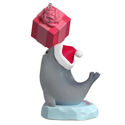 Granddaughter — 2025 Hallmark Keepsake Christmas Ornament featuring a grey seal in a Santa hat balancing a pink gift on its nose.