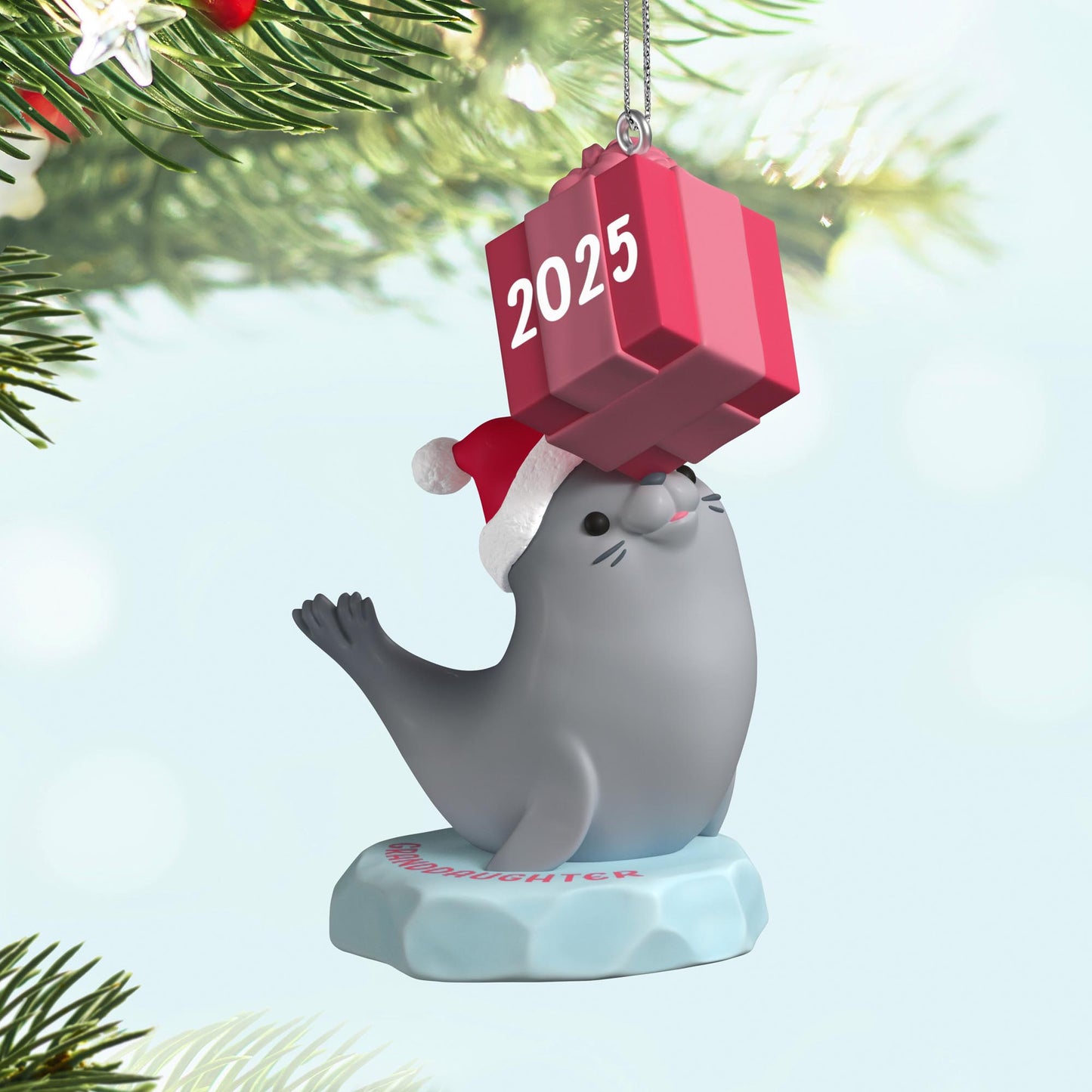 Granddaughter — 2025 Hallmark Keepsake Christmas Ornament featuring a grey seal in a Santa hat balancing a pink gift.