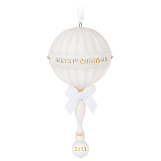 Baby's First Christmas (2023) Porcelain Rattle — Hallmark Keepsake Christmas Ornament, white with gold accents and a ribbon bow, hanging display.