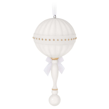 Baby's First Christmas (2023) Porcelain Rattle — Hallmark Keepsake Christmas Ornament in white with gold accents and ribbon detail, hanging view.