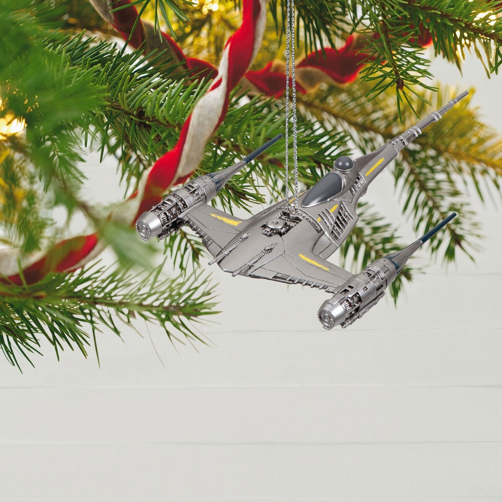 Star Wars™: The Mandalorian, The Mandalorian's N—1 Starfighter ornament hanging from a Christmas tree branch with decorative ribbon.