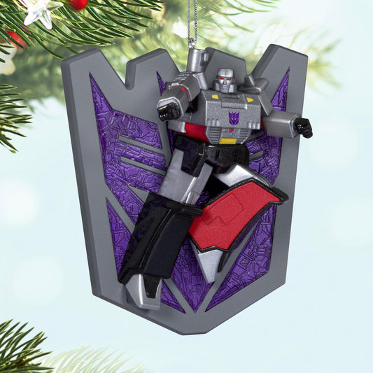 Transformers™, Megatron's Might — 2025 Hallmark Keepsake Christmas Ornament, detailed figure against Decepticon shield, close-up view.