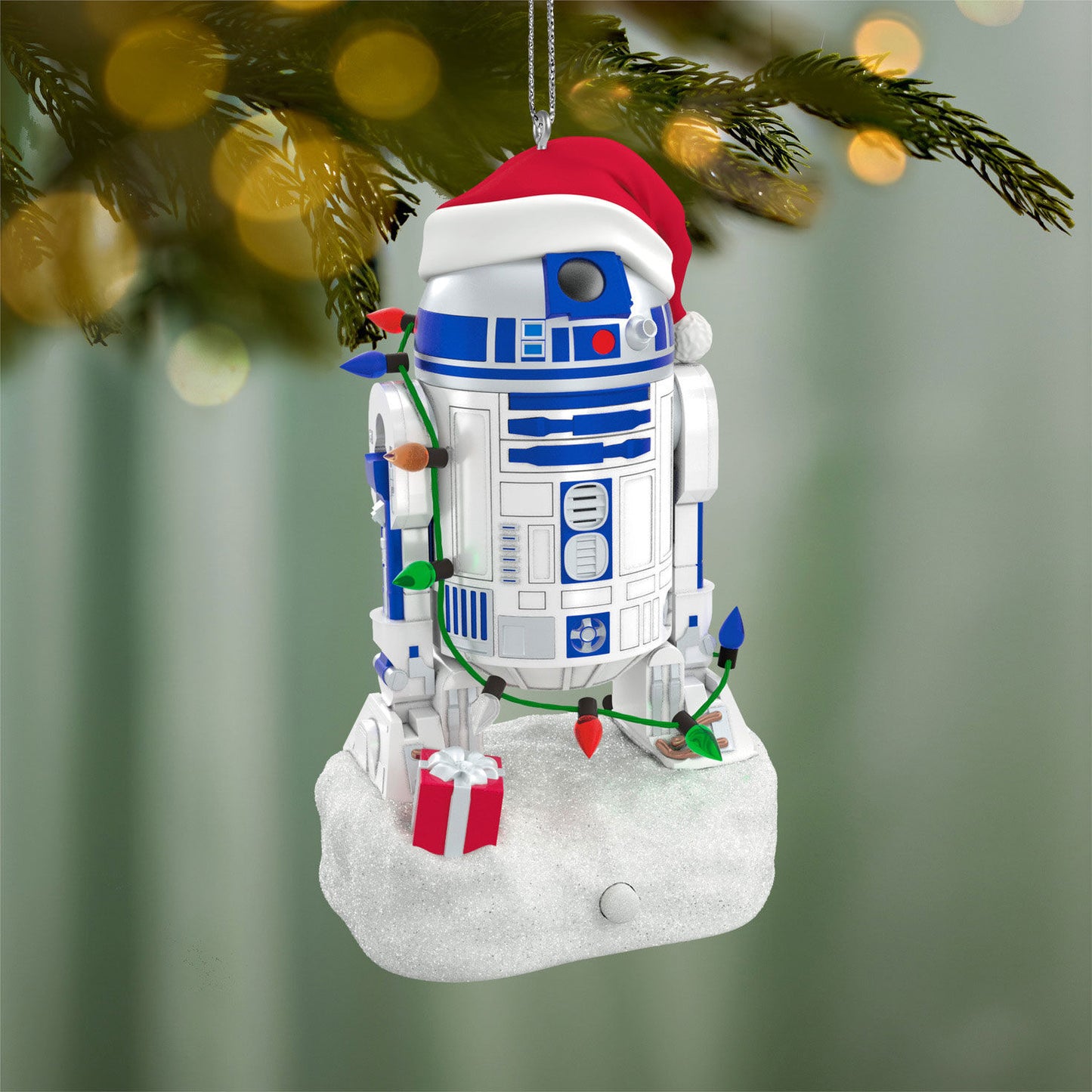 Star Wars™ Decked-Out Droid Musical — 2026 Hallmark Keepsake Christmas Ornament hanging on a tree, wearing a Santa hat and decorative lights.