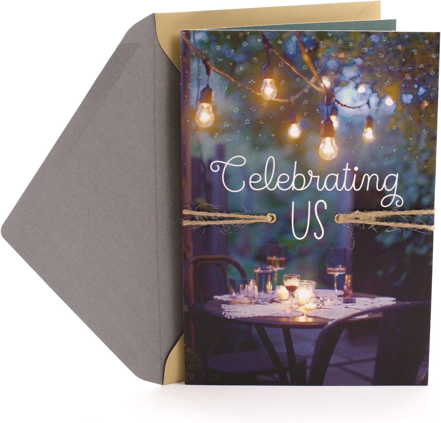 Hallmark Our Anniversary Card Celebrating us Love, Celebrating us with bistro lights, natural twine and elegant design, flat lay view.