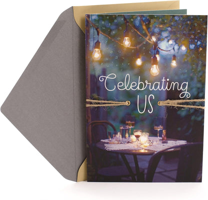Hallmark Our Anniversary Card Celebrating us Love, Celebrating us with bistro lights, natural twine and elegant design, flat lay view.
