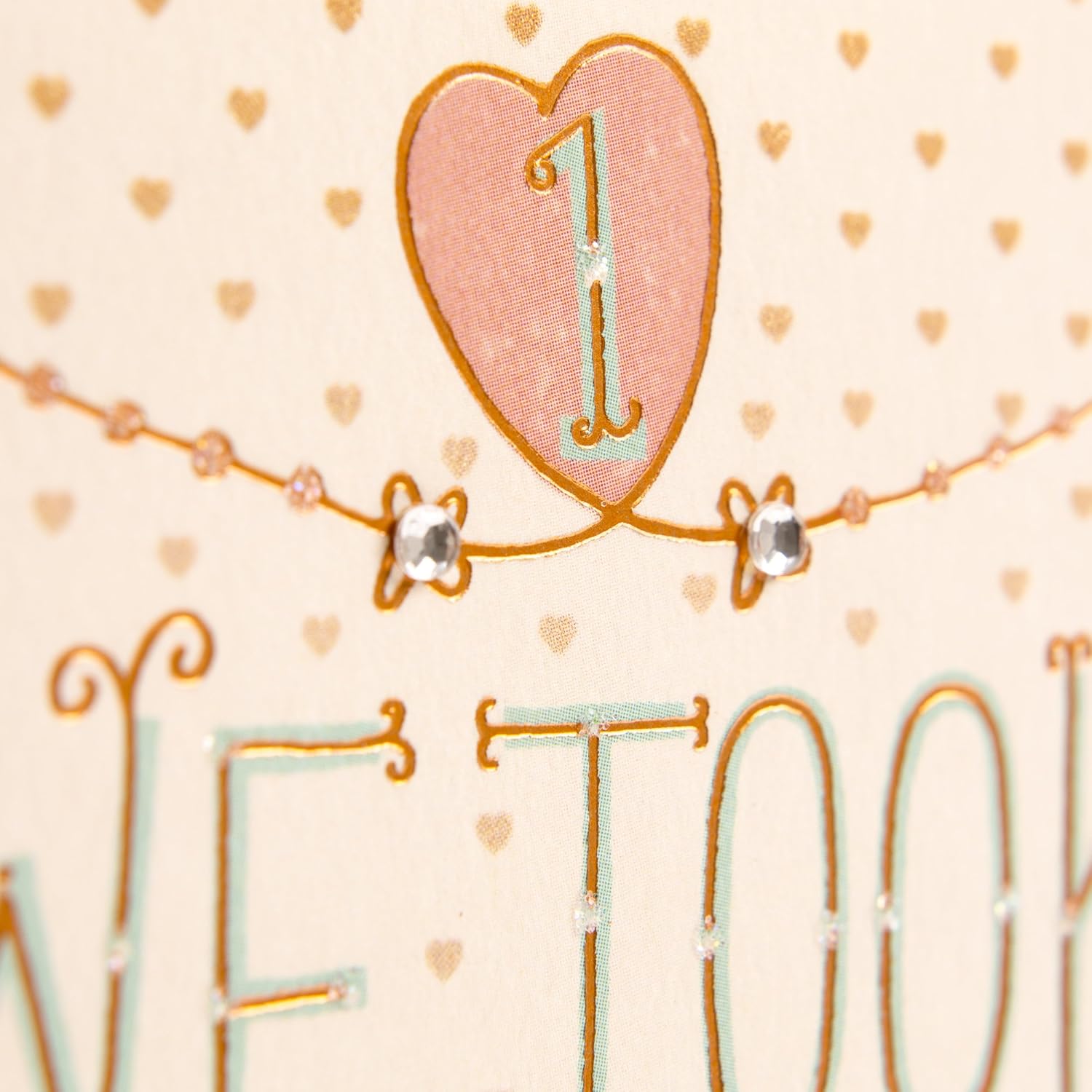 Hallmark 1st Anniversary Card (Chance on What Could Be) close up of glitter accent and hand lettering in pink and gold design