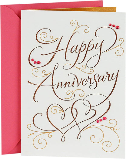 Hallmark Signature Anniversary Card for Couple (Happy Anniversary) with glittery lettering and pink envelope, flat lay view.