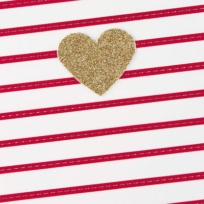 Hallmark Signature Women's Birthday Greeting Card (Heart and Stripes) with a gold glitter heart on red striped background, flat lay view.