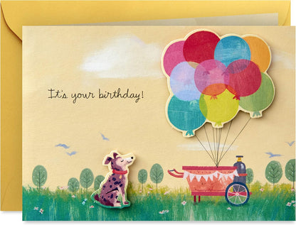 Hallmark Paper Wonder Pop Up Birthday Card (Get Carried Away) featuring a dog and colourful balloons, front view with envelope.