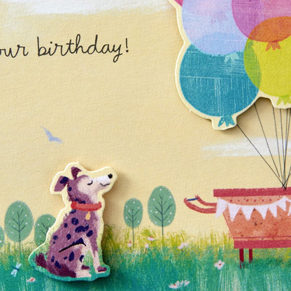 Hallmark Paper Wonder Pop Up Birthday Card (Get Carried Away) close up of playful dog illustration beside colourful balloons.
