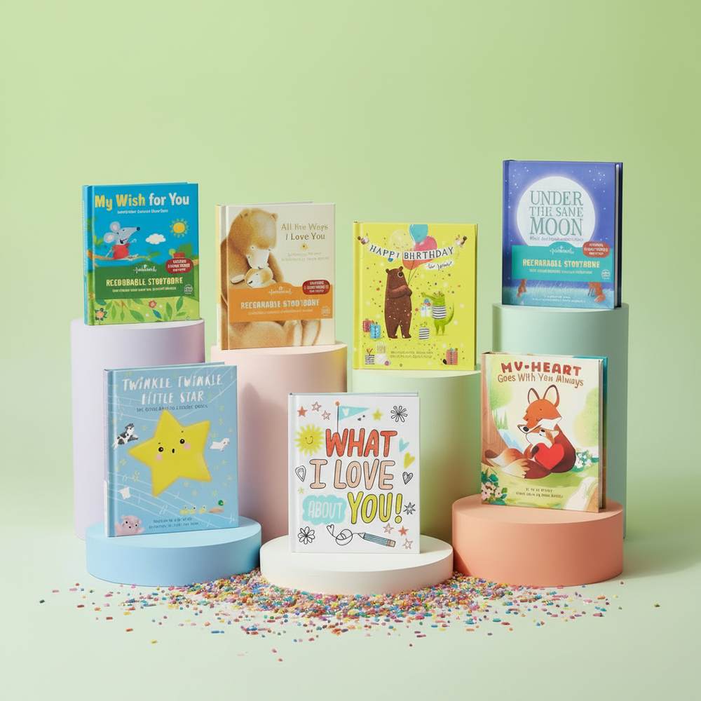 Collection of children's recordable books on colorful cylindrical stands against a light green background