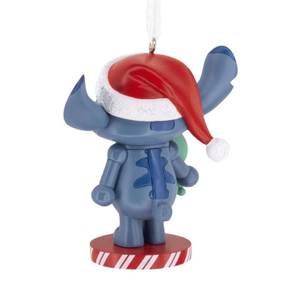 Disney Stitch Nutcracker - Hallmark Christmas Ornament, blue alien character with Santa hat and Lilo's doll, rear view.