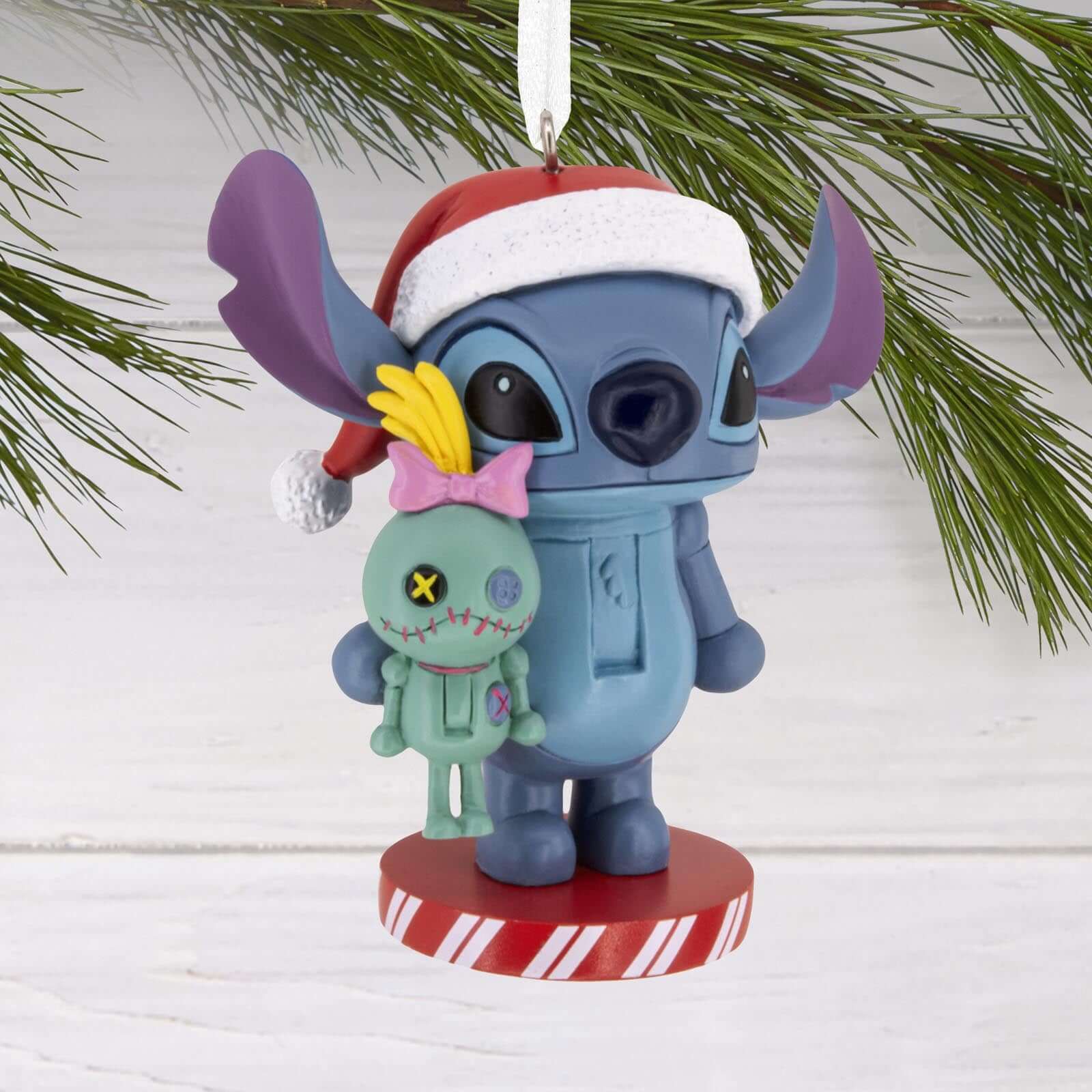 Disney Stitch Nutcracker - Hallmark Christmas Ornament featuring Stitch in a Santa hat holding Lilo's doll Scrump, detailed view.