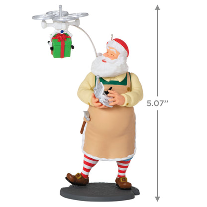 Toymaker Santa — Hallmark Keepsake Christmas Ornament, 12.9 cm figure with drone delivering a gift, playful factory scene.