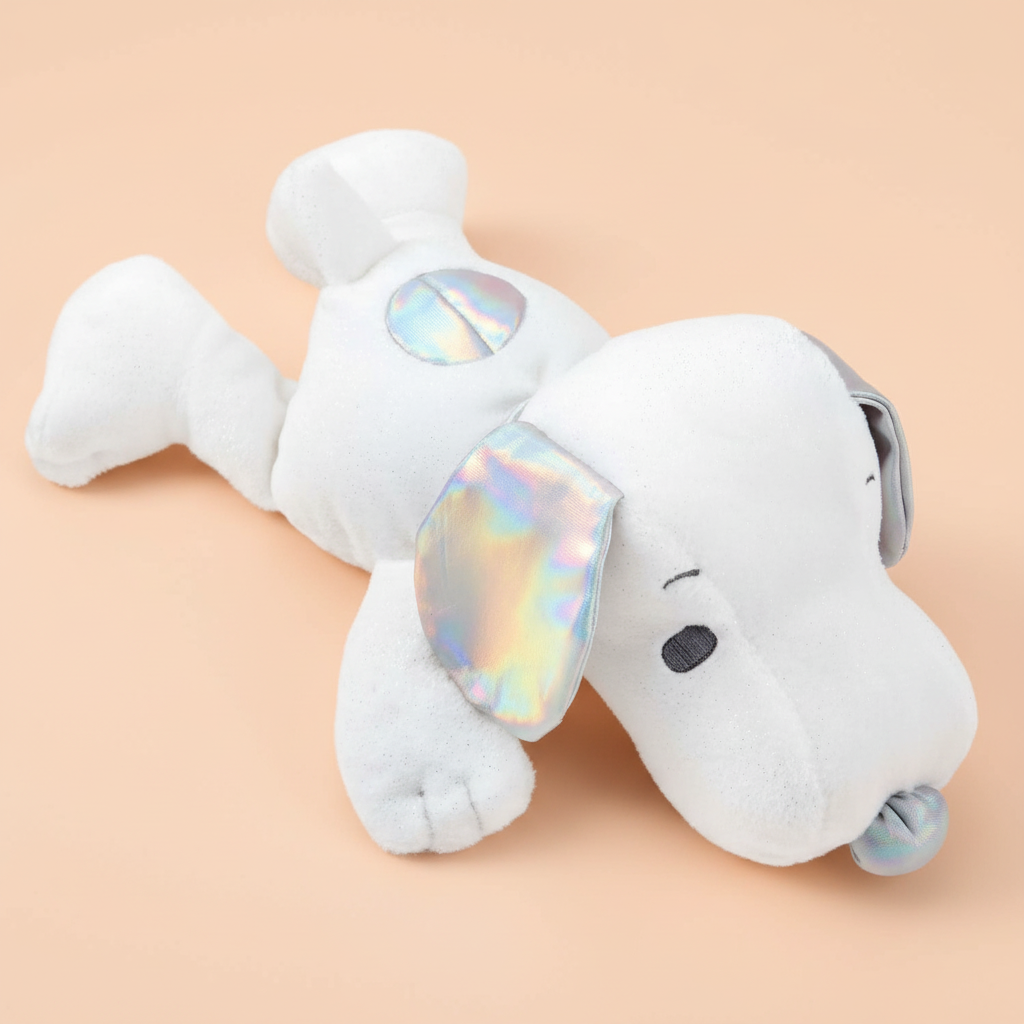 Peanuts Snoppy White plush dog toy with iridescent ears on a beige background