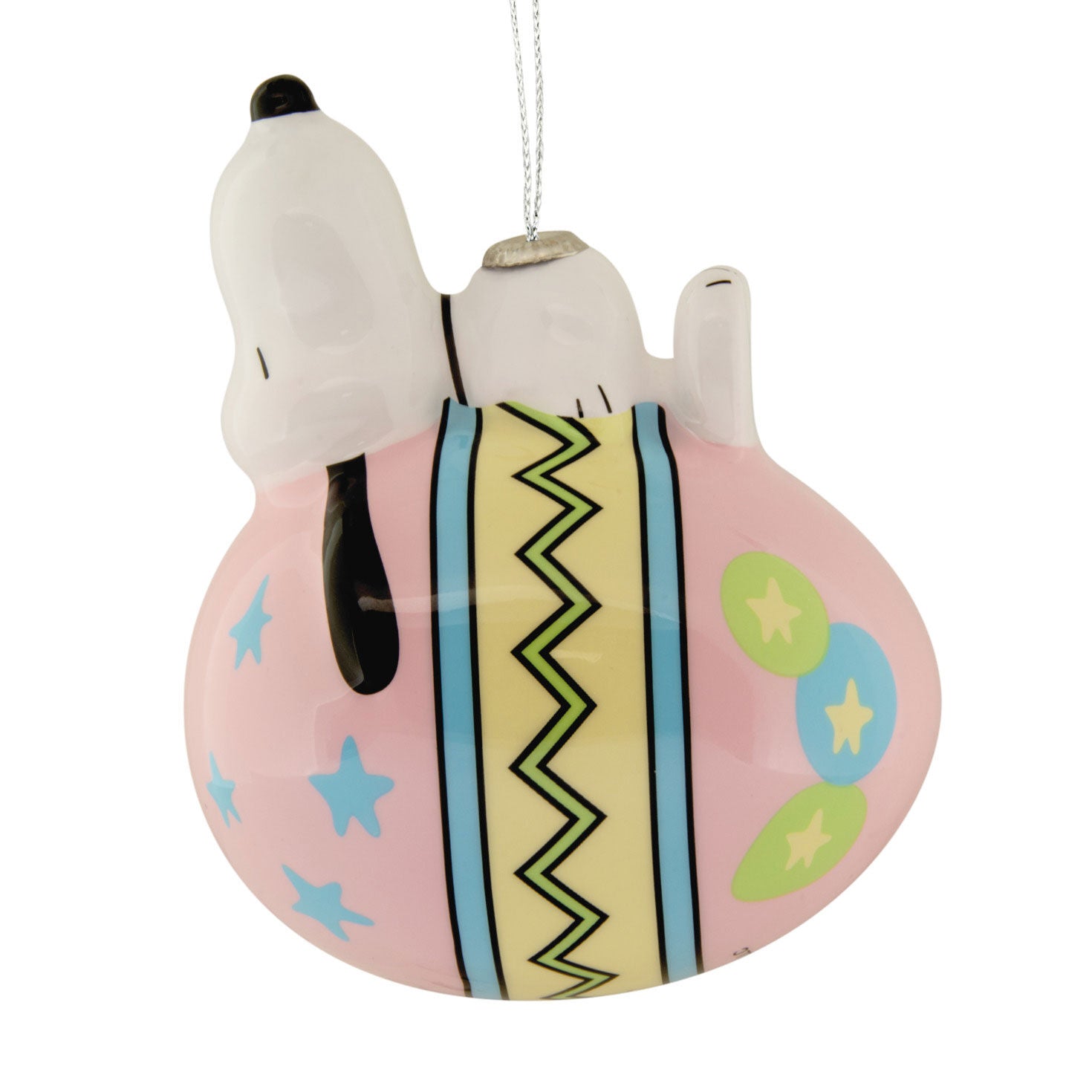 Decorative ornament featuring a dog character sleeping on a pink pillow with colorful patterns.
