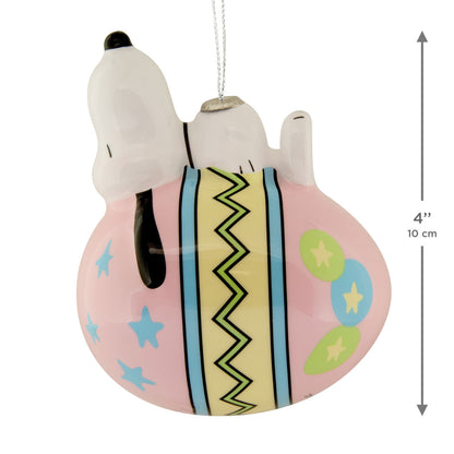 Decorative ornament of a dog character on a pink ball with colorful patterns, featuring a measurement indicator.