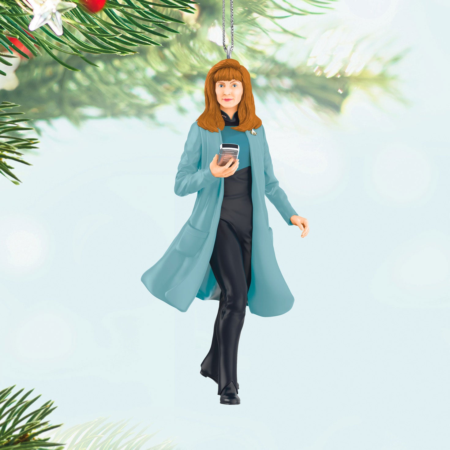 Star Trek™: The Next Generation Dr. Beverly Crusher — Hallmark Keepsake Christmas Ornament showing a 3D figure in a blue lab coat, holding a medical tricorder, hanging among Christmas tree branches.