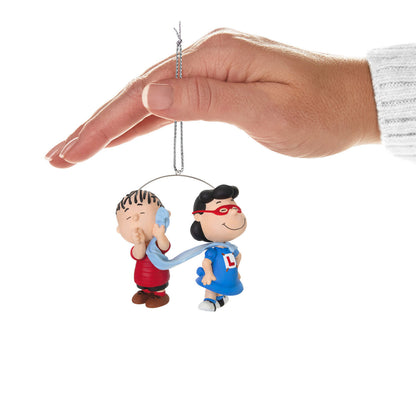 The Peanuts® Gang, Super Lucy and Linus — Hallmark Keepsake Christmas Ornament featuring Lucy as a superhero with Linus' blanket as a cape, being held.