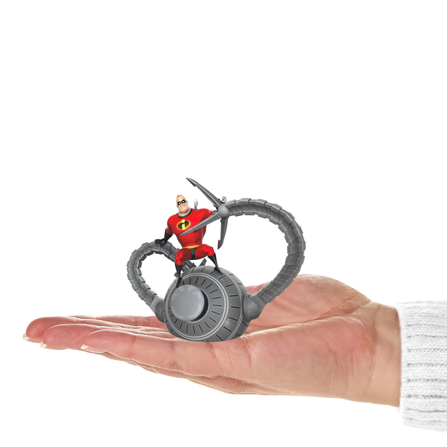 Disney and Pixar The Incredibles, 20th Anniversary Battling the Omnidroid — Hallmark Keepsake Christmas Ornament in a hand, showing detail of Mr. Incredible and Omnidroid.