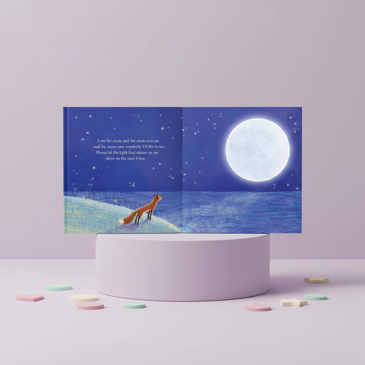 Children's book with a fox and moon illustration on a stand against a light purple background