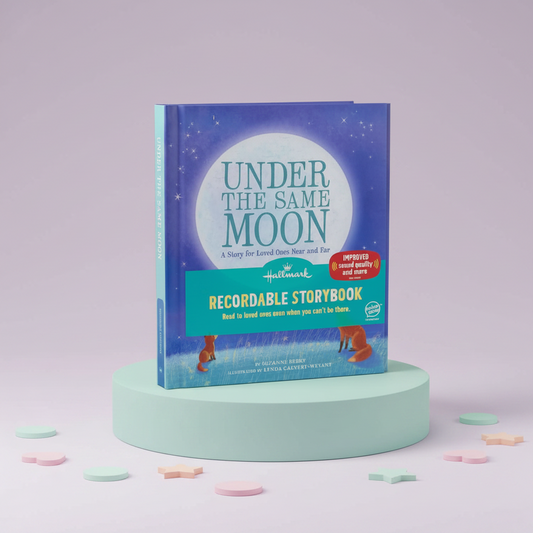 Recordable storybook titled 'Under the Same Moon' on a light green pedestal with a light purple background.