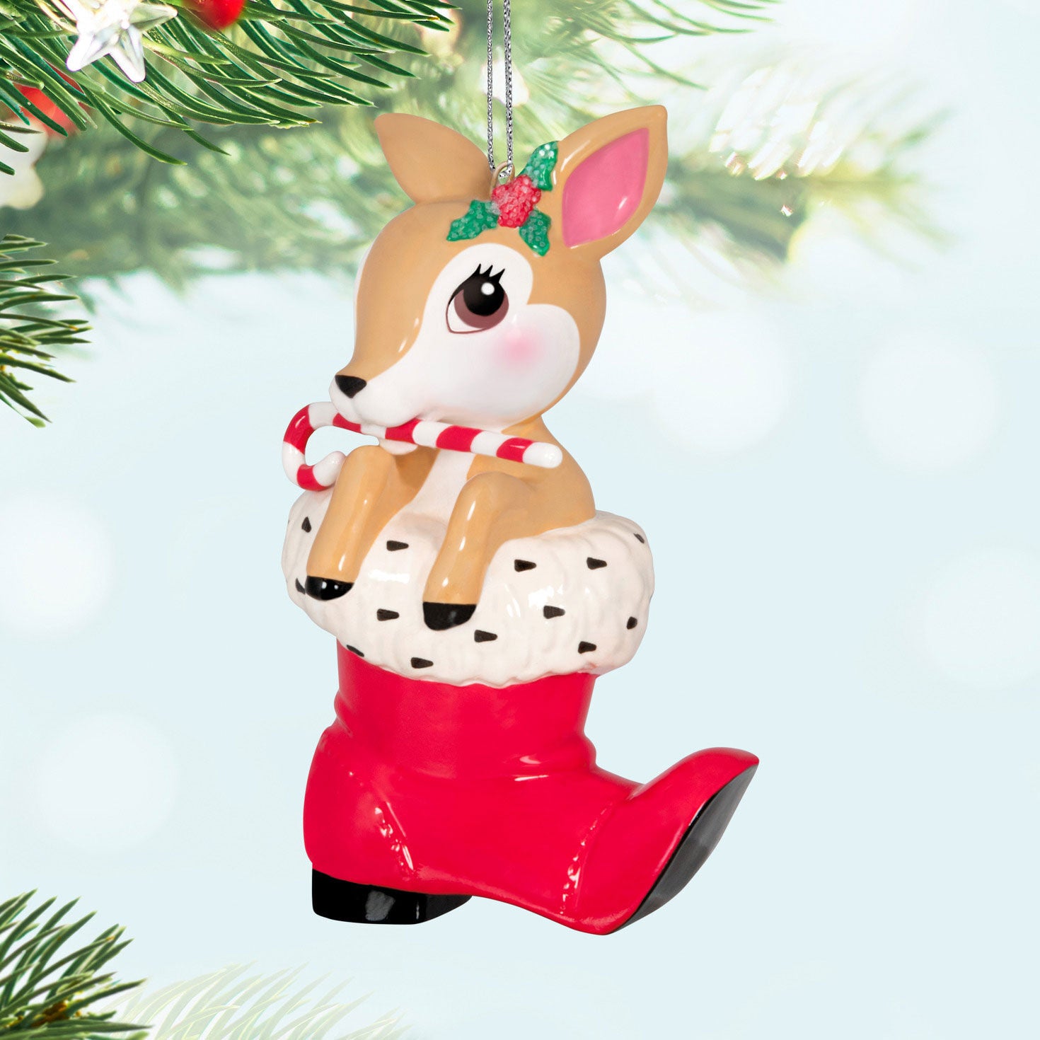 Vintage Reindeer Porcelain — Hallmark Keepsake Christmas Ornament featuring a reindeer with a candy cane in a red Santa boot, hanging from a tree.