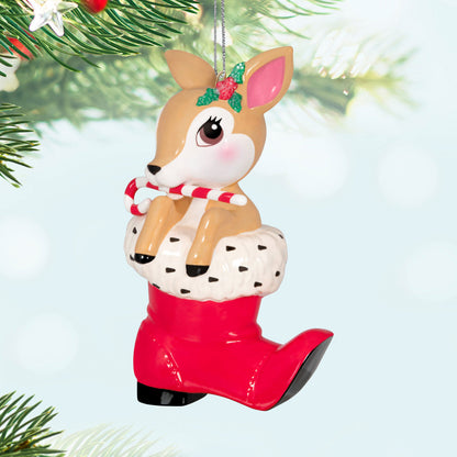 Vintage Reindeer Porcelain — Hallmark Keepsake Christmas Ornament featuring a reindeer with a candy cane in a red Santa boot, hanging from a tree.