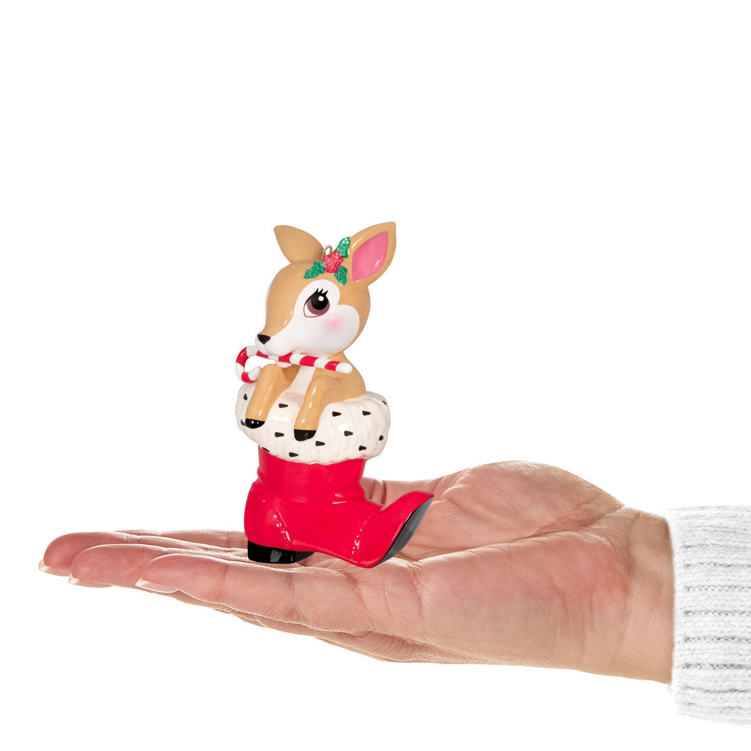 Vintage Reindeer Porcelain — Hallmark Keepsake Christmas Ornament in a hand, detailed design with candy cane and red Santa boot.