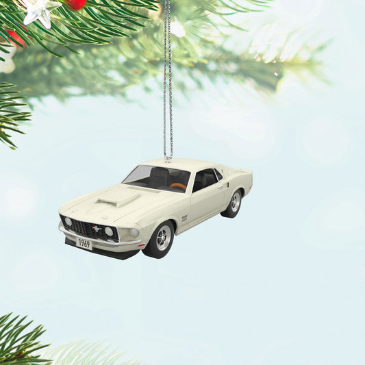Lil' Classic Cars 1969 Ford Mustang Boss 429 (Miniature) — Hallmark Keepsake Christmas Ornament in white, hanging from a pine branch, showcasing detailed design.