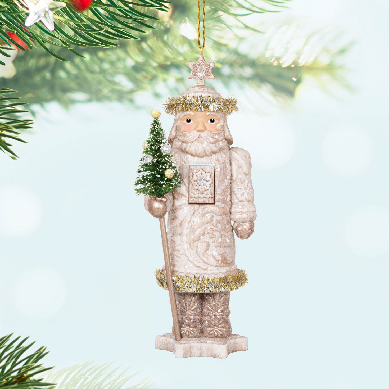 Noble Nutcrackers Earl of Snowfall — Hallmark Keepsake Christmas Ornament, white nutcracker holding a small tree, hanging ornament.