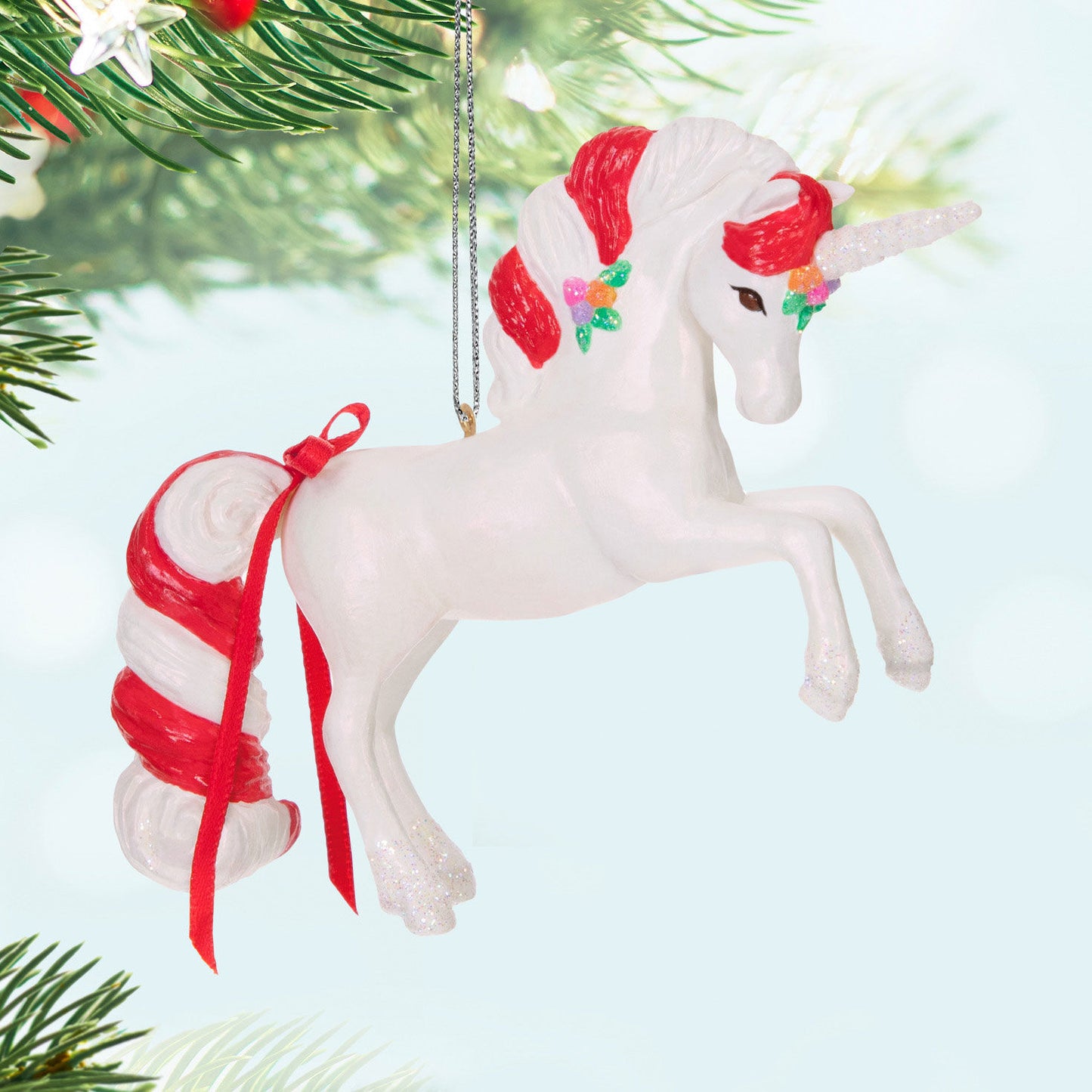 Sweet Unicorn — Hallmark Keepsake Christmas Ornament featuring a candy cane mane and a glittery horn, suspended from a tree.