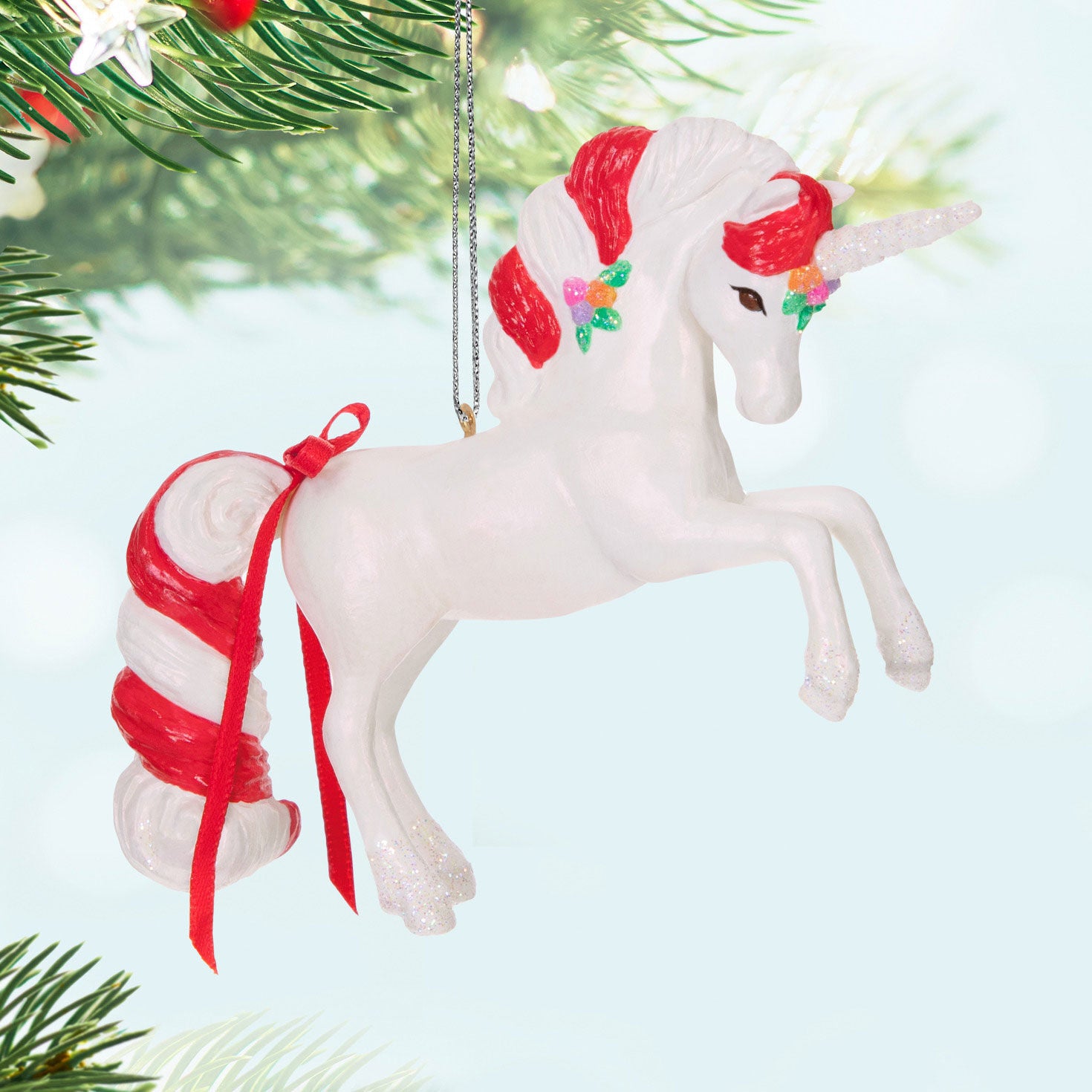 Sweet Unicorn — Hallmark Keepsake Christmas Ornament featuring a candy cane mane and a glittery horn, suspended from a tree.