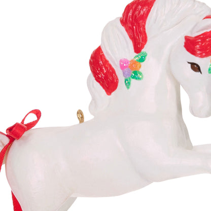 Sweet Unicorn — Hallmark Keepsake Christmas Ornament, white unicorn with candy cane-striped mane and decorative flowers, close up view.