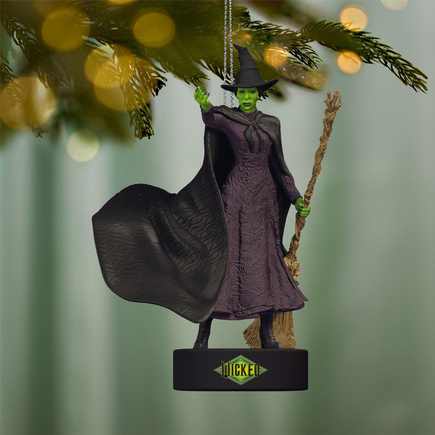 Wicked Defying Gravity With Sound — 2026 Hallmark Keepsake Christmas Ornament featuring the Wicked Witch of Oz in black and green, hanging from a tree branch in a close-up view.