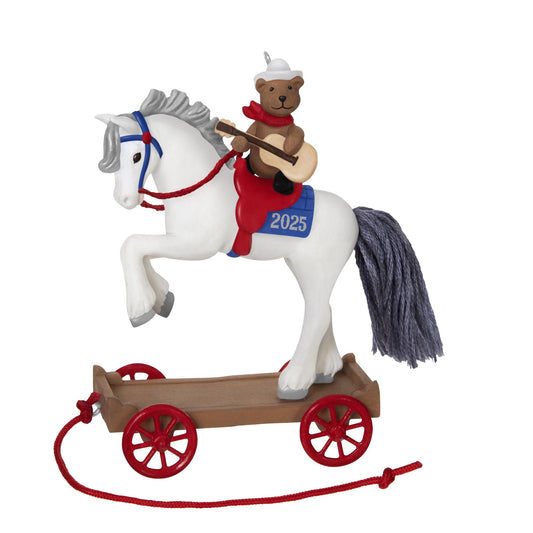 A Pony for Christmas, 28th in the Series — 2025 Hallmark Keepsake Christmas Ornament featuring a white horse with a teddy bear and guitar on a wooden platform.