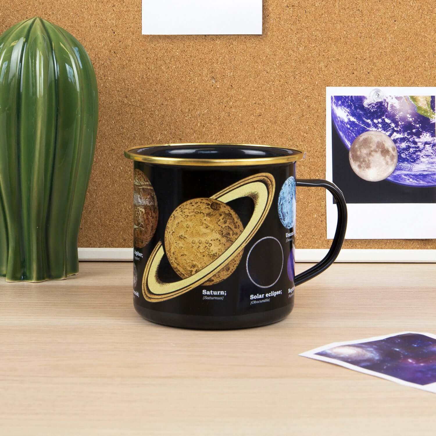 Gift Republic - Astronomia Enamel Mug featuring planetary designs, displayed on a desk with a cactus plant and educational images.
