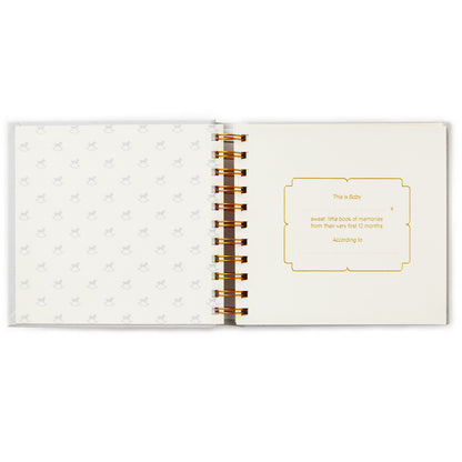 Sweet Baby's First Year Baby Book open view, featuring gold foiled text on soft patterned pages with concealed wire binding.