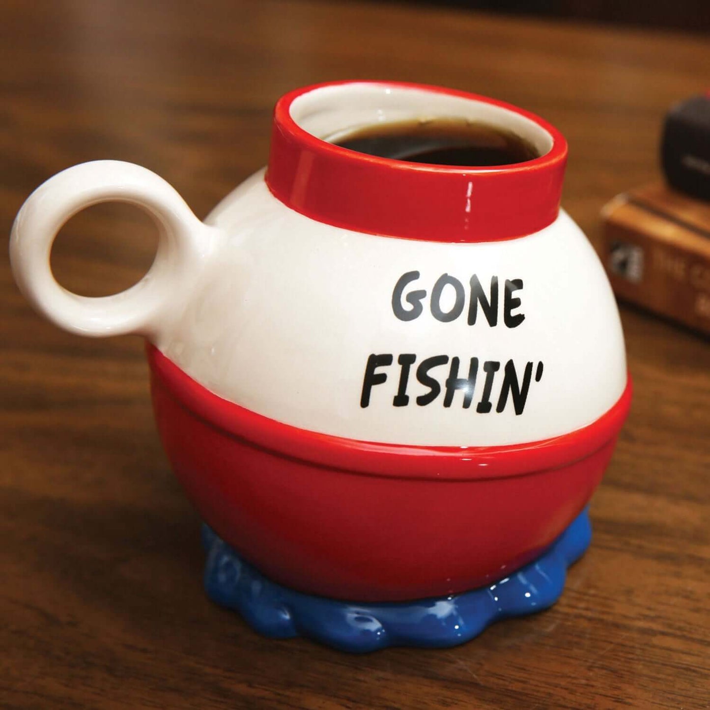 BigMouth - Gone Fishin' Mug, ceramic coffee cup, 20 oz size, featuring a red and white fishing bobber design, angled view
