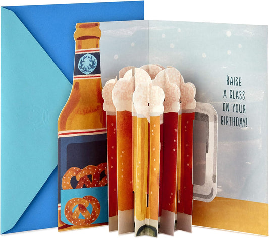 Hallmark Paper Wonder Displayable Pop Up Birthday Card (Beer) featuring a beer mug pop-up and die-cut bottle design, in a vibrant blue envelope.