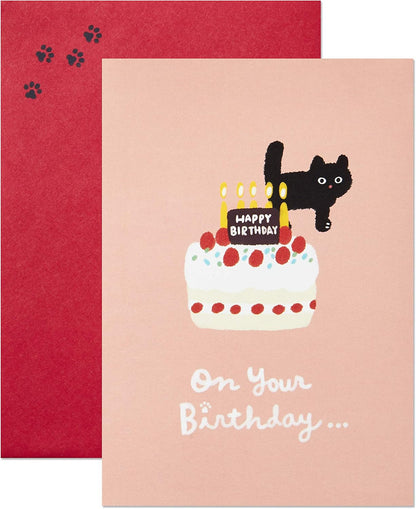 Hallmark Pop Up Birthday Card (Cat and Friend with Birthday Cake) featuring a playful black cat on a birthday cake against a pink background.