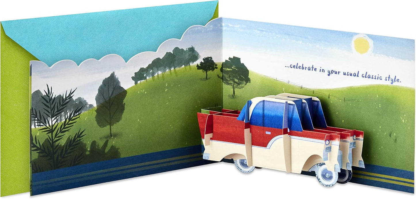 Hallmark Paper Wonder Displayable Pop Up Birthday Card (Classic Car) with a 3D pop-up truck design and vibrant landscape illustration.