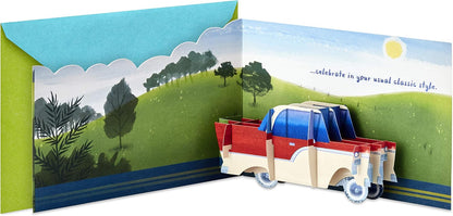 Hallmark Paper Wonder Displayable Pop Up Birthday Card (Classic Car) with a 3D pop-up truck design and vibrant landscape illustration.