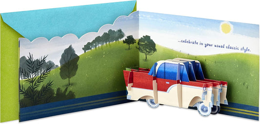 Hallmark Paper Wonder Displayable Pop Up Birthday Card (Classic Car) with a 3D pop-up truck design and vibrant landscape illustration.