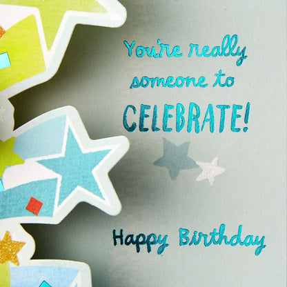 Hallmark Paper Wonder Pop Up Birthday Card (Someone to Celebrate) design featuring colourful stars and the message 'You're really someone to celebrate!'