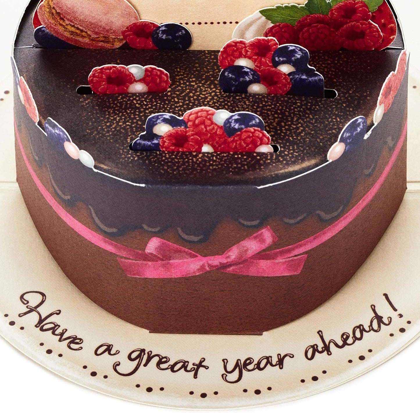 Hallmark Pop Up Birthday Card (Chocolate Cake) featuring a 3D chocolate cake design with berries and a pink ribbon, flat view.