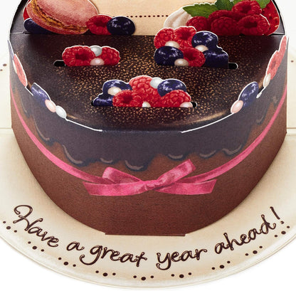 Hallmark Pop Up Birthday Card (Chocolate Cake) featuring a 3D chocolate cake design with berries and a pink ribbon, flat view.